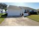 House exterior with a two-car garage and manicured lawn at 3000 Peace River Dr, Punta Gorda, FL 33983