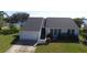 White and gray house with a dark gray roof, a two-car garage, and a well-manicured lawn at 3000 Peace River Dr, Punta Gorda, FL 33983