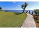 Wooden walkway leads to a private dock with serene waterfront views at 3000 Peace River Dr, Punta Gorda, FL 33983