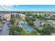 Aerial view of condo complex, pool, tennis courts, and parking at 3006 Caring Way # 331, Port Charlotte, FL 33952