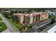 Aerial view of condo building with parking and landscaping at 3006 Caring Way # 331, Port Charlotte, FL 33952