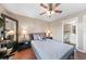 Bright bedroom with double bed, ceiling fan, and ensuite bathroom access at 3006 Caring Way # 331, Port Charlotte, FL 33952