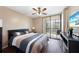 Bedroom with king-size bed, balcony access, and ceiling fan at 3006 Caring Way # 331, Port Charlotte, FL 33952