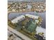 Aerial view showing condo community, tennis court, and pool at 3600 Bal Harbor Blvd # 1A, Punta Gorda, FL 33950