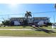 Front view of a two-story building with landscaping, showcasing its appealing facade at 3627 Bal Harbor Blvd # 102, Punta Gorda, FL 33950