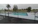 Community pool with fence and lounge chairs at 3627 Bal Harbor Blvd # 102, Punta Gorda, FL 33950