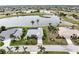 Aerial view of a home on a golf course with a lake nearby at 3749 Bordeaux Dr, Punta Gorda, FL 33950