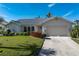 Single-story home with a two-car garage and well maintained lawn at 3749 Bordeaux Dr, Punta Gorda, FL 33950