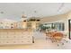 Kitchen island with seating and views into living room at 3749 Bordeaux Dr, Punta Gorda, FL 33950