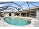 Large kidney-shaped pool with screened enclosure and lake view at 3749 Bordeaux Dr, Punta Gorda, FL 33950