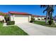 Attached garage with driveway and landscaping at 3830 Bal Harbor Blvd # 5, Punta Gorda, FL 33950