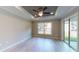 Bright bedroom with light wood flooring, ceiling fan, and sliding glass doors at 4393 Antioch St, North Port, FL 34288