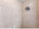 Walk-in shower with beige tile and a rain shower head at 4398 Appleton Ter, North Port, FL 34286