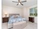 Bright bedroom features a decorative headboard with a neutral-toned storage bench at 43996 Boardwalk Loop # 1411, Punta Gorda, FL 33982