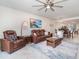 A comfortable living room showcases modern furniture, a ceiling fan, and an open layout for entertaining at 43996 Boardwalk Loop # 1411, Punta Gorda, FL 33982