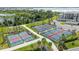 Aerial view of pickleball courts with green landscaping and walking paths at 43996 Boardwalk Loop # 1411, Punta Gorda, FL 33982