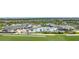 An aerial view of a community pool featuring several lounge chairs, mature palm trees, and pristine landscaping at 43996 Boardwalk Loop # 1411, Punta Gorda, FL 33982