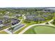 Aerial view of tennis and bocce ball courts with green landscaping and blue skies at 43996 Boardwalk Loop # 1411, Punta Gorda, FL 33982