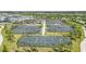 Aerial view of community tennis courts with green landscaping and blue skies at 43996 Boardwalk Loop # 1411, Punta Gorda, FL 33982