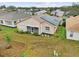 Rear view of house with solar panels and a partially landscaped yard at 483 Winwood Ct, Port Charlotte, FL 33954