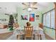 Bright dining room with a floral tablecloth, wooden chairs, and a Christmas tree at 483 Winwood Ct, Port Charlotte, FL 33954