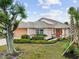 Front view of single story house with landscaped yard at 483 Winwood Ct, Port Charlotte, FL 33954