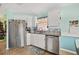 Clean kitchen with stainless steel appliances, white cabinets, and a tiled backsplash at 483 Winwood Ct, Port Charlotte, FL 33954