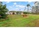 Landscaped lawn and a one-story house with a driveway at 5273 Crestline Ter, Port Charlotte, FL 33981