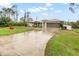 House with a wet driveway and green grass at 5273 Crestline Ter, Port Charlotte, FL 33981