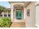 Welcoming front entry with teal double doors and arched entryway at 5273 Crestline Ter, Port Charlotte, FL 33981