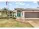 Single-Gathering home with teal front doors and attached garage at 5273 Crestline Ter, Port Charlotte, FL 33981