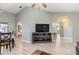 Open concept living area with wood floors, a sectional sofa, and dining area at 5273 Crestline Ter, Port Charlotte, FL 33981