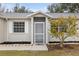 Inviting front entrance with screened porch and landscaping at 5452 Montego Ln, Port Charlotte, FL 33981