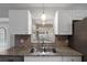 Modern kitchen featuring granite countertops and a double sink at 5452 Montego Ln, Port Charlotte, FL 33981