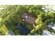 Aerial view of tennis courts and pond in a community at 6642 Acacia Ct, North Port, FL 34287