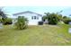 Home's exterior with a well-maintained lawn and tropical landscaping at 6642 Acacia Ct, North Port, FL 34287