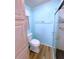 Clean bathroom with shower, toilet, and light blue walls at 6642 Acacia Ct, North Port, FL 34287