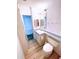 Small bathroom with wood-look flooring, toilet and vanity with a sink at 6642 Acacia Ct, North Port, FL 34287