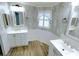 Bathroom boasts double vanity, wood-look floors, and updated fixtures at 6642 Acacia Ct, North Port, FL 34287