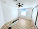 Spacious bedroom with ceiling fan, window, and laminate flooring at 6642 Acacia Ct, North Port, FL 34287