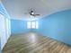 Bright bedroom with ceiling fan and wood-look flooring at 6642 Acacia Ct, North Port, FL 34287