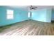 Spacious bedroom with light blue walls and wood-look floors at 6642 Acacia Ct, North Port, FL 34287