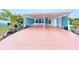 Mobile home with carport, and a pink colored driveway at 6642 Acacia Ct, North Port, FL 34287