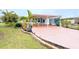 Front view of a mobile home with a carport and palm trees at 6642 Acacia Ct, North Port, FL 34287