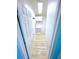 Clean hallway with light flooring and storage at 6642 Acacia Ct, North Port, FL 34287