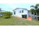 White mobile home with a small porch and green lawn at 6642 Acacia Ct, North Port, FL 34287