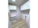 Laundry room with white cabinets and wood-look floors at 6642 Acacia Ct, North Port, FL 34287