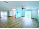 Open living room with wood-look flooring and view of kitchen at 6642 Acacia Ct, North Port, FL 34287