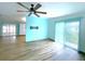 Spacious living room with ceiling fan and wood-look flooring at 6642 Acacia Ct, North Port, FL 34287