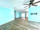 Open living area with light blue walls and wood-look floors at 6642 Acacia Ct, North Port, FL 34287